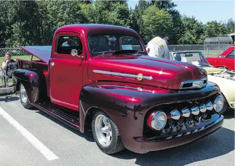  ?? PHOTOS: CAM HUTCHINS ?? Mark and Debbie Johnston’s 1952 Ford F1 pickup is two-tone red, with darker red fenders and extra chromed grille “teeth.”