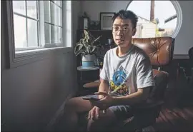  ?? Jason Armond Los Angeles Times ?? EDEN CHEN, chief executive of Pragma and Fishermen Labs, in his L.A. home office. Chen uses the app WeChat to communicat­e with businesses in China.