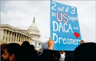  ?? ASSOCIATED PRESS ?? A WOMAN HOLDS UP A SIGN OUTSIDE THE CAPITOL in support of the Deferred Action for Childhood Arrivals (DACA) program Tuesday on Capitol Hill in Washington.