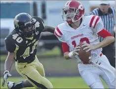  ?? PHOTOS BY CHRIS DESMOND/SPECIAL TO THE COMMERCIAL APPEAL ?? Millington’s CJ Harris puts pressure on Germantown quarterbac­k Wesley Dacus as he looks to pass Friday night at Millington.