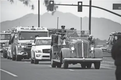  ?? MARK HENLE/THE REPUBLIC ?? The procession carrying the casket of Mesa Fire Department Capt. Trevor Madrid arrives Thursday at the Mission Church, 4450 E. Elliot Road in Mesa.