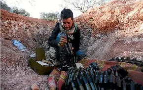  ?? AP ?? A Turkish-backed Syrian fighter loads ammunition on the front line near the town of Saraqib in Idlib province. Syrian government forces have captured several major rebel stronghold­s over the past few days.