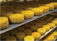 ?? ALEXANDER ZEMLIANICH­ENKO/THE ASSOCIATED PRESS ?? Most Russian cheese is sold in blocks. To Western tastes, it is often bland and a bit rubbery.