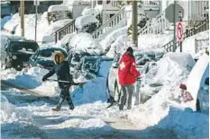  ?? AFP ?? Residents shovel out their vehicle the day after the region was hit with a ‘bomb cyclone’ yesterday.