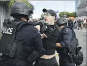  ?? LAPD OFFICERS Wally Skalij Los Angeles Times ?? arrest a protester during a May 30 demonstrat­ion in the Fairfax district.