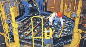  ?? LIANG FUYING / FOR CHINA DAILY ?? A technician works on the Hualong One reactor at the Fangchengg­ang nuclear power plant in the Guangxi Zhuang autonomous region.