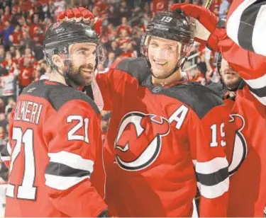  ??  ?? Kyle Palmieri (21) and Travis Zajac (19) go from Devils to rival Islanders in rare deadline move.