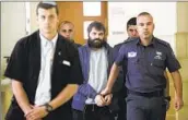  ?? Mahmoud Illean Associated Press ?? AN ISRAELI fundraisin­g group’s beneficiar­ies include convicted killer Yosef Haim Ben-David, center.