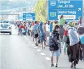  ?? Foto: dpa ?? 4. September: 2000 Flüchtling­e machen sich zu Fuß auf der Autobahn auf den Weg von Ungarn nach Österreich