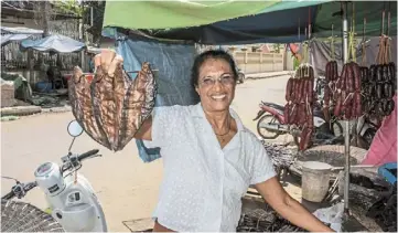  ??  ?? Good, healthy food: Thilsted holding prepared fish in a market in Cambodia. her pond polycultur­e system has helped millions of people worldwide put nutritious food on their plates, earning her the prestigiou­s award.
