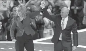  ?? AP/JOHN LOCHER ?? Former Rep. Gabrielle Giffords of Arizona and her husband, former astronaut Mark Kelly, acknowledg­e the crowd after speaking Wednesday at the Democratic convention. Giffords, who was seriously wounded in a 2011 shooting, and Kelly talked about the need...