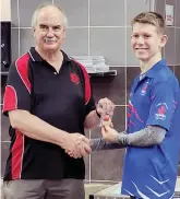  ?? ?? South African Air Rifle Federation president Johan Pienaar commends Aidan Ellof for his achievemen­ts.