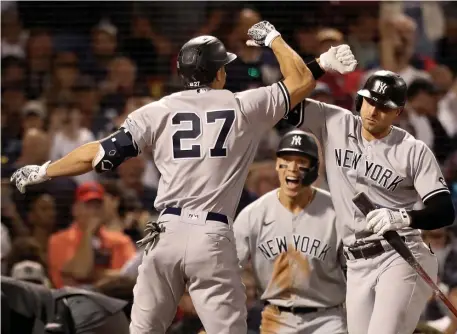  ?? Nancy lane pHotoS / Herald Staff ?? DEJA VU: Yankees slugger Giancarlo Stanton, left, celebrates his two-run home run with Joey Gallo during the eighth inning on Sunday night at Fenway Park. Below, Bobby Dalbec misplays a foul pop up during the inning.