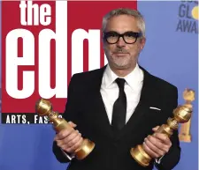  ?? AP PHOTO ?? LEADING THE WAY: Alfonso Cuaron poses with his Golden Globe awards for ‘Roma.’