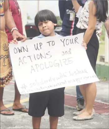  ??  ?? One of several children present at yesterday’s protest, which was a show of solidarity for the nine-year-old Mae’s student who was humiliated and allegedly discrimina­ted against when he wore his indigenous attire to the culture day activity last week. (Terrence Thompson photo)