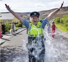  ??  ?? Garda Mary Gardiner getting a bucket of water thrown over her during the filming of the viral ‘Amarillo’ clip. Photos by Domnick Walsh.