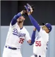  ?? AP photo ?? Dodgers outfielder­s Mookie Betts (right) and Cody Bellinger collide while attempting to make a catch during the first inning Wednesday against the Angels. Betts suffered a cracked right rib on the play.