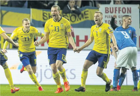  ??  ?? Sweden’s Jakob Johansson, No.13, roars in delight after scoring against Italy.