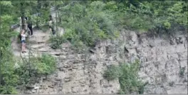  ?? JOHN RENNISON, THE HAMILTON SPECTATOR ?? A woman takes a photograph from a perch on the escarpment opposite Albion Falls on Sunday.