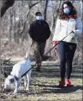  ?? Tyler Sizemore / Hearst Connecticu­t Media ?? Amanda Vitti and Fred Jones walk their dog Echo outside their home in New Milford on Jan. 24.