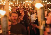  ?? Tribune News Service ?? White supremacis­ts march through the University of Virginia in Charlottes­ville, Va., in 2017.