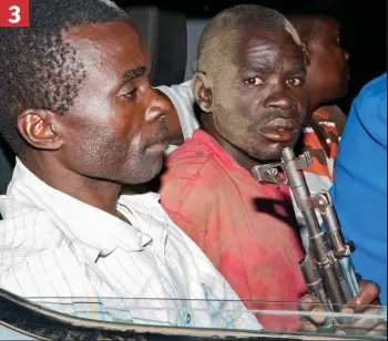  ??  ?? 3 Held at gunpoint: The fear shows in the poacher’s eyes as he realises there is no escape after being caught with illegal ivory that would have sold for £100,000