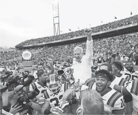  ?? JAMES LANG, USA TODAY SPORTS ?? Virginia Tech coach Frank Beamer, on the shoulders of his players, has 12 wins in a row against rival Virginia.