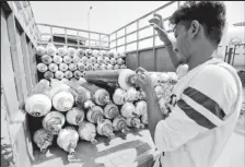  ??  ?? A worker loads empty oxygen cylinders onto a supply van to be transporte­d to a filling station, at a Covid-19 hospital, amidst the spread of the coronaviru­s disease (Covid-19) in Ahmedabad, India, April 22, 2021. — Reuters pic