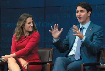  ?? AP PHOTO ?? Foreign Affairs Minister Chrystia Freeland looks on as Prime Minister Justin Trudeau responds to a question during a panel discussion at the Council on Foreign Relations in New York on Tuesday.