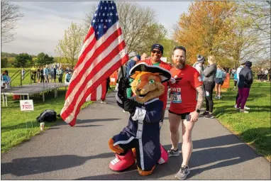  ?? PHOTO BY DYLAN EDDINGER ?? Monty the Fox poses with runners at the 18th annual Valley Forge Revolution­ary 5-Mile Run and 2-mile walk.