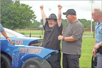  ?? Cat Webb ?? Jacob Davis celebrates a chance to wear a Georgia state trooper’s hat Wednesday.