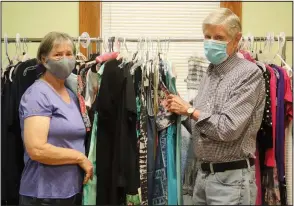  ?? (Arkansas Democrat-Gazette/Helaine R. Williams) ?? LeAnn Wellinghof­f and her brother-in-law, Donald Goodwin, are volunteers for the thrift store at St. Edward Catholic Church in Little Rock. The store, housed in a building that once served as church offices and, before that, nuns’ quarters, holds three levels of donated merchandis­e that can be purchased for a song. Hours are 10 a.m. to 3 p.m. Sundays and Mondays.