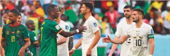  ?? AFP ?? Cameroon Serbia players greet each other after the match at Al Janoub Stadium.