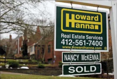  ?? GENE J. PUSKAR — THE ASSOCIATED PRESS FILE ?? In this Monday file photo, a for sale sign is displayed in front of a home in Mount Lebanon, Pa. Economists are generally bullish in their outlooks for 2018: Most expect the new U.S. tax cuts, a sturdier global economy and a healthy job market to...