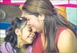  ?? THE ASSOCIATED PRESS ?? Allison, 6, and her mother, Cindy Madrid, share a moment Friday during a news conference in Houston, where they spoke about the month they were separated.
