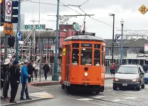  ??  ?? Riding a cable car is a must for a first-time visitor to San Francisco. Better yet, ride it to Fisherman’s Wharf.