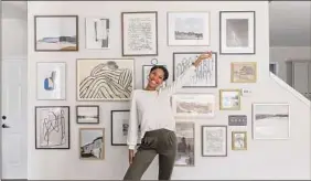  ?? Provided by Tiffany DeLangie / Via The Washington Post ?? Tiffany DeLangie with one of her gallery walls.