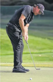  ?? USA TODAY SPORTS ?? Phil Mickelson putts on the 17th green during the final round of the WGC - FedEx St. Jude Invitation­al golf tournament at TPC Southwind in Tennessee on Aug. 2.