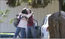  ?? ASSOCIATED PRESS ?? Two women embrace outside Rancho Tehama Elementary School, where a gunman opened fire Tuesday in Corning, Calif. Authoritie­s said, a gunman choosing targets at random, opened fire in the rural Northern California town, killing four people at several...