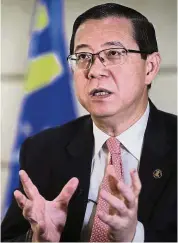  ?? — AP ?? Revenue boost: Lim says the reintroduc­tion of the SST, rising crude oil prices and dividends from GLCs will bring in RM15bil revenue.