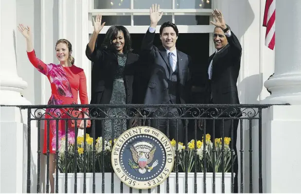  ?? CHIP SOMODEVILL­A / GETTY IMAGES ?? Sophie Grégoire-Trudeau, left, U. S. first lady Michelle Obama, Prime Minister Justin Trudeau and U. S. President Barack Obama
wave to invited guests from the White House’s Truman Balcony after an arrival ceremony Thursday in Washington, D.C.