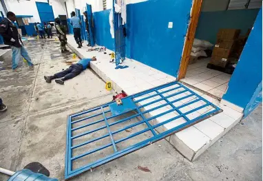  ??  ?? Violent escape: The body of a guard who died during the jailbreak is seen inside the Civil Prison in the coastal town of Arcahaie, Haiti. — AP