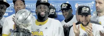  ?? ERIC GAY/THE ASSOCIATED PRESS ?? Golden State Warriors’ Draymond Green carries the NBA Western Conference trophy as Kevin Durant, left rear, and Stephen Curry, front right, cheer after their 129-115 win over the San Antonio Spurs in Game 4 of the Western Conference finals, Monday in...