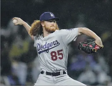  ?? Gregory Bull Associated Press ?? DODGERS starting pitcher Dustin May went five innings, giving up five hits and four runs (three earned).