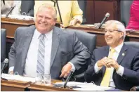  ?? CP PHOTO ?? Ontario Premier Doug Ford, left, shares a joke with Finance Minister Vic Fedeli during Question Period at the Ontario Legislatur­e in Toronto on Monday.