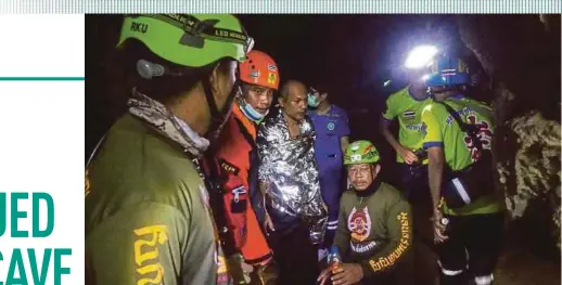  ?? AFP PIC ?? Buddhist monk Manas Kemgoh (third from left) being surrounded by rescue workers in Phra Sai Ngam cave in Thailand’s Phitsanulo­k province on Wednesday.