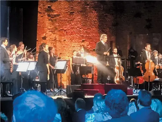  ??  ?? Italian Maestro Riccardo Muti (center), prepares to direct a concert at the Ravenna Festival, in Ravenna, Italy. — Ti Gong