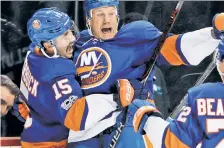  ??  ?? GOAL! Long Island hockey fans are as jubilant as their heroes (above) after word came Tuesday that the team will leave Barclays Center (left) in Brooklyn to play at a new Nassau County arena to be built next to Belmont Park (below).