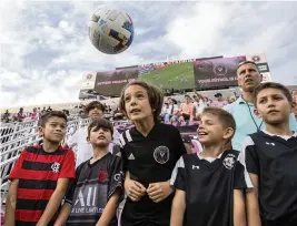  ?? DANIEL A. VARELA dvarela@miamiheral­d.com ?? Fort Lauderdale resident and Inter Miami fan Chris Martinov, 11, heads the ball back onto the field during the open training session at DRV PNK Stadium on Saturday.