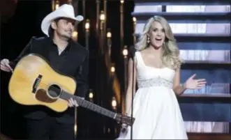  ?? PHOTO BY WADE PAYNE — INVISION — AP, FILE ?? In this file photo, hosts Brad Paisley, left, and Carrie Underwood appear at the 48th annual CMA Awards in Nashville, Tenn. Paisley and Underwood are celebratin­g their 10year anniversar­y as hosts of the Country Music Associatio­n Awards.